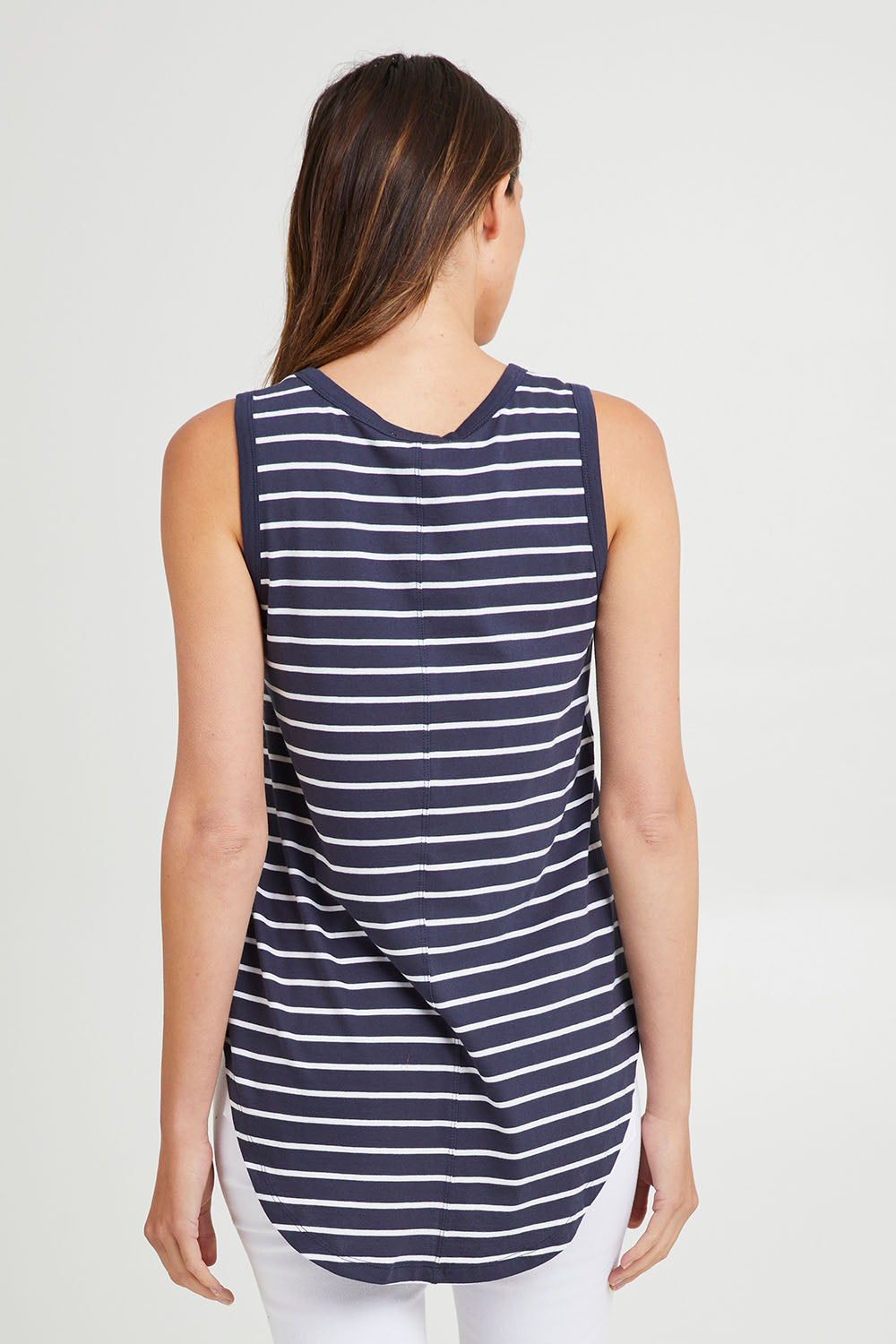 Model Madeline wearing size 10 of the Keira Tank in colour Bluestrp (Blue), from the back