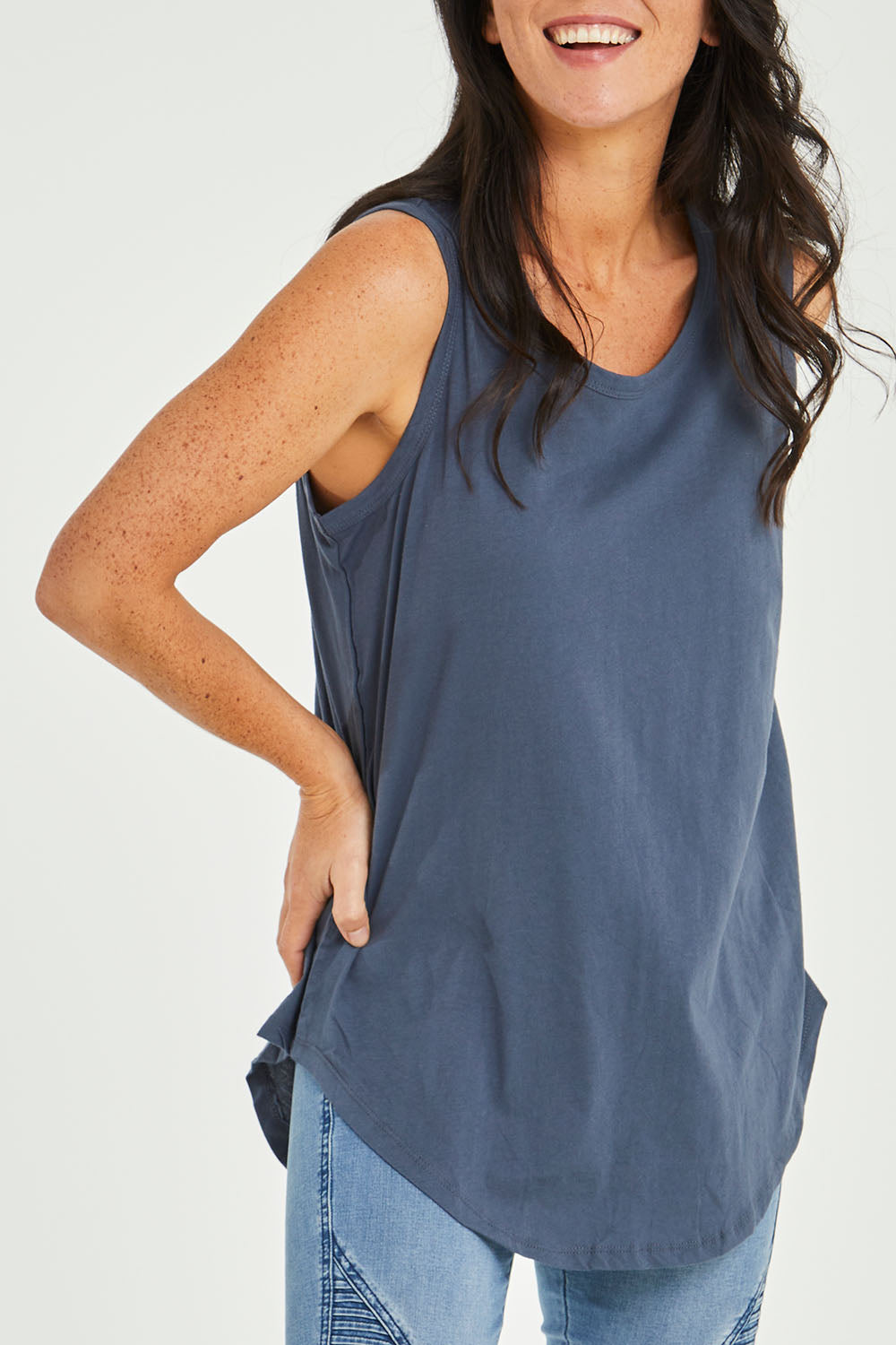 Model Katie wearing size 10 of the Keira Tank in colour Indiblue (Blue), from the front, cropped image