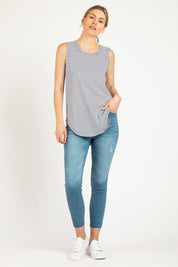 A model wearing the Keira Tank in colour Indistripe (Blue), from the front, showing the whole outfit