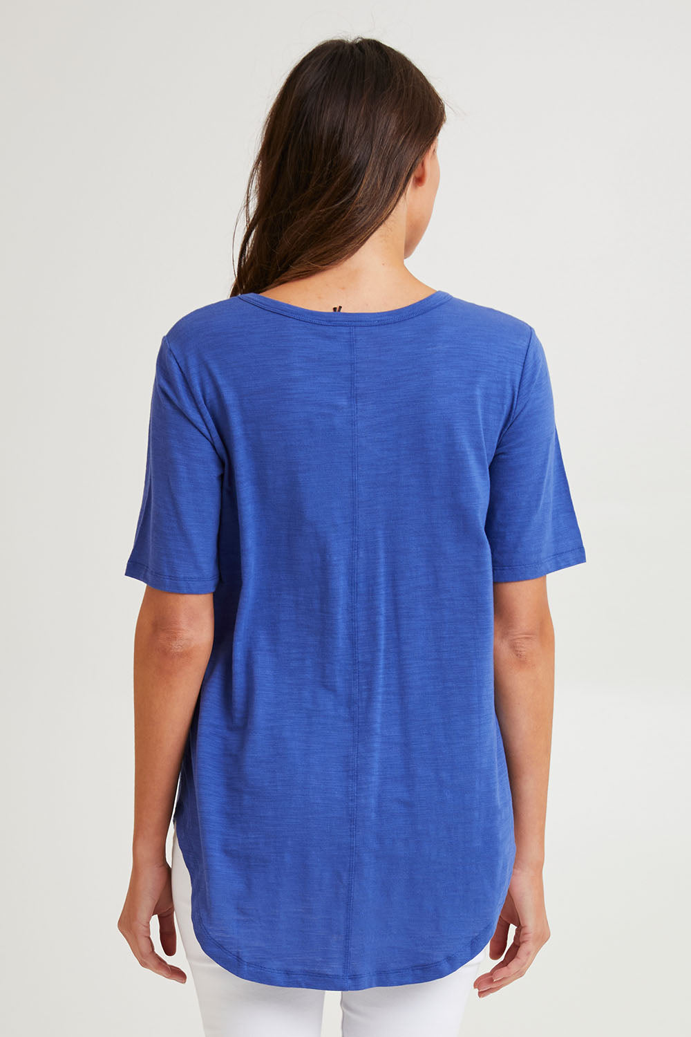 Model Madeline wearing size 10 of the Ariana Cotton Tee in colour Oceanblue (Blue), from the back