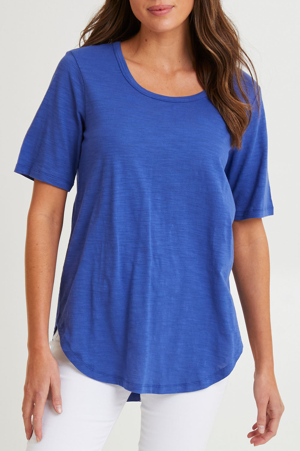 Model Madeline wearing size 10 of the Ariana Cotton Tee in colour Oceanblue (Blue), from the front, cropped image