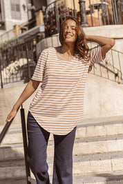 A model wearing the Ariana Cotton Tee in colour Beigestrip, from the front, showing the whole outfit
