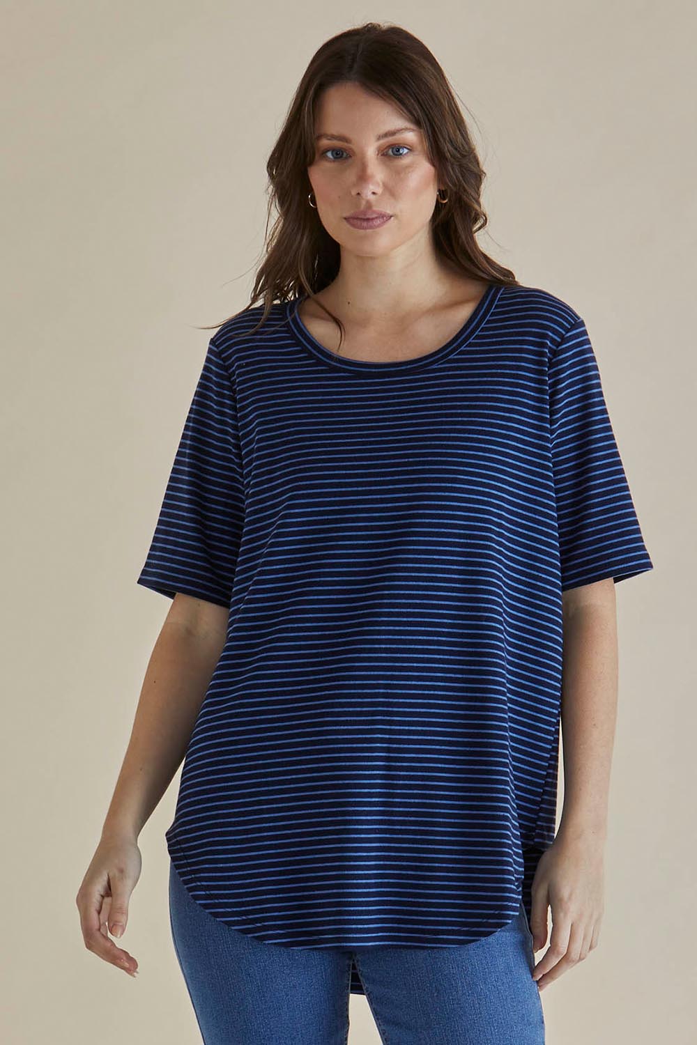 A model wearing the Ariana Cotton Tee in colour Bluestripe (Blue), from the front, cropped image