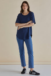 A model wearing the Ariana Cotton Tee in colour Bluestripe (Blue), from the front, showing the whole outfit