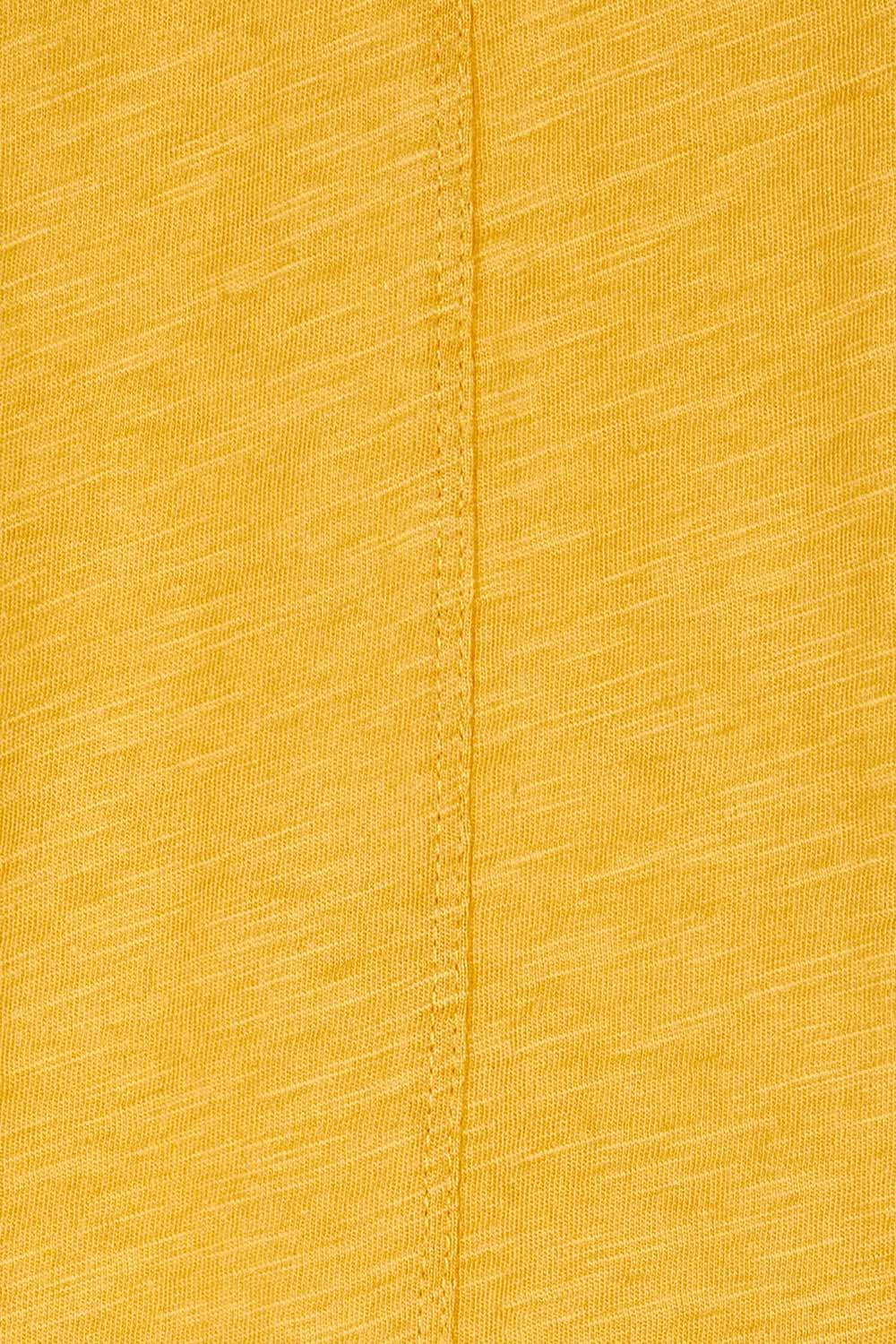 Product shot of the Ariana Tee in colour Mustard, detail