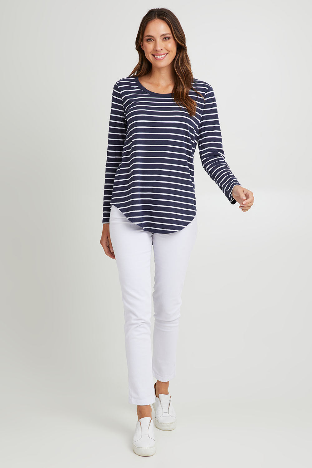 Model Madeline wearing size 10 of the Megan Long Sleeve Top in colour Bluestrp (Blue), from the front, showing the whole outfit