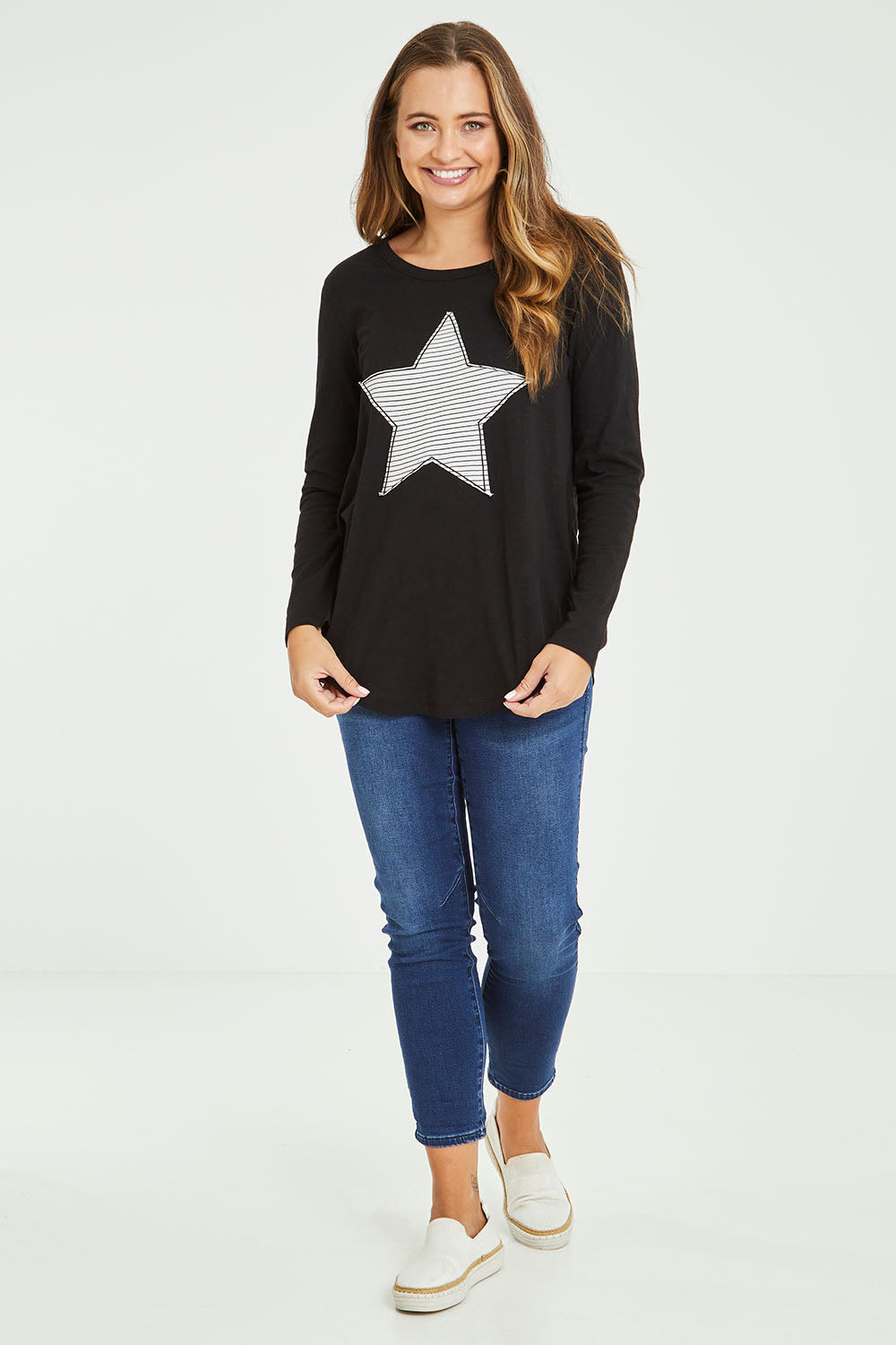 Model Tahlia wearing size 10 of the Megan L/S Top in colour Stripestar (Black), from the front, showing the whole outfit