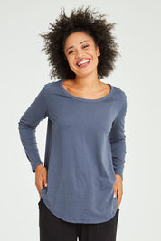 Model Olivia wearing size 10 of the Megan Long Sleeve Top in colour Indiblue (Blue), from the front, cropped image