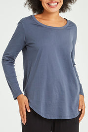 Model Olivia wearing size 10 of the Megan Long Sleeve Top in colour Indiblue (Blue), from the front, cropped image