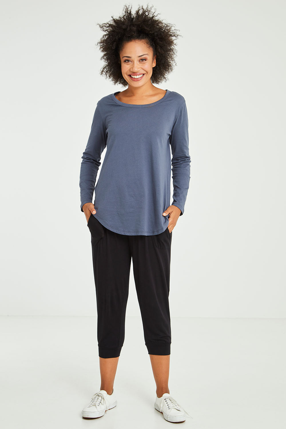 Model Olivia wearing size 10 of the Megan Long Sleeve Top in colour Indiblue (Blue), from the front, showing the whole outfit