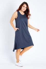 Model Laura wearing size 12 of the Arwin Dress in colour Indiblue (Blue), from the front, showing the whole outfit