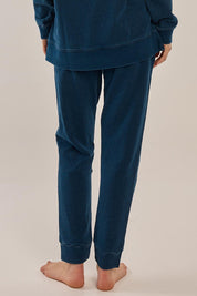 A model wearing the Heidi Pant in colour Indigo (Blue), from the back