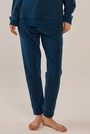 A model wearing the Heidi Pant in colour Indigo (Blue), from the front, cropped image