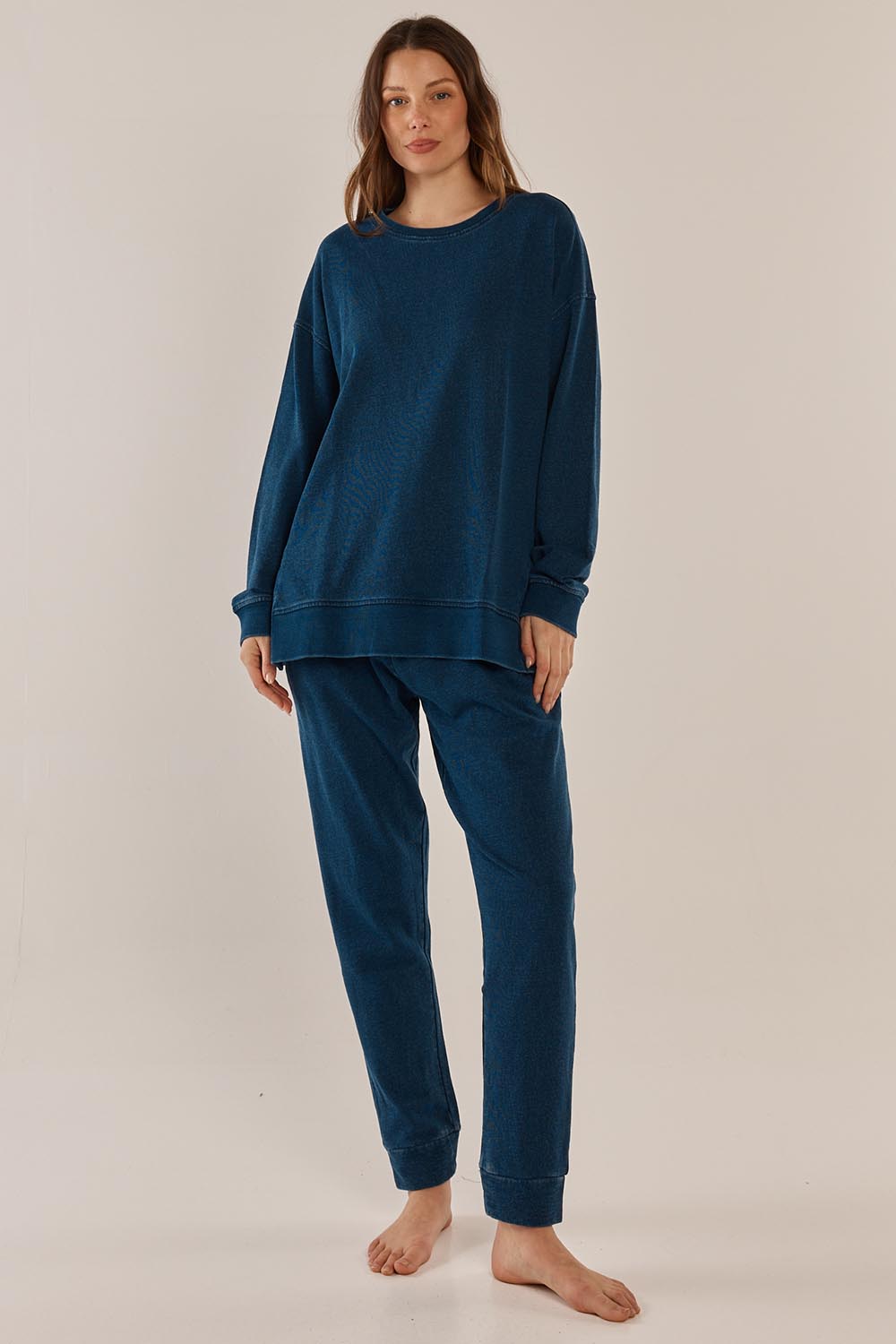 A model wearing the Heidi Pant in colour Indigo (Blue), from the front, showing the whole outfit