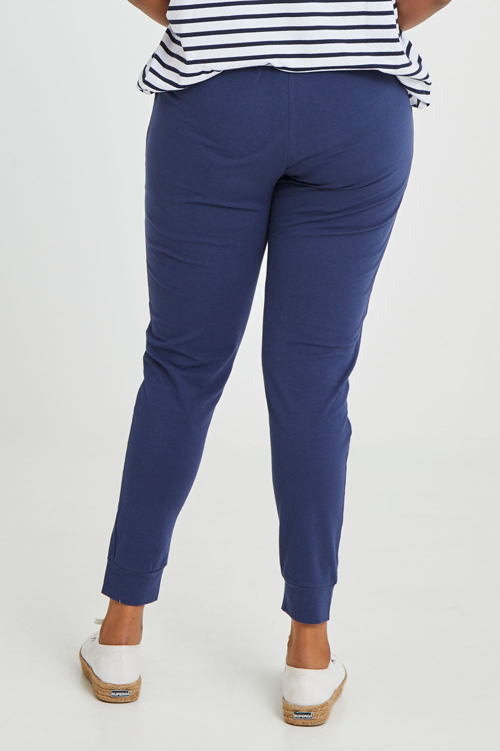 Model Noli wearing size 14 of the Heidi Pant in colour Navy (Blue), from the back