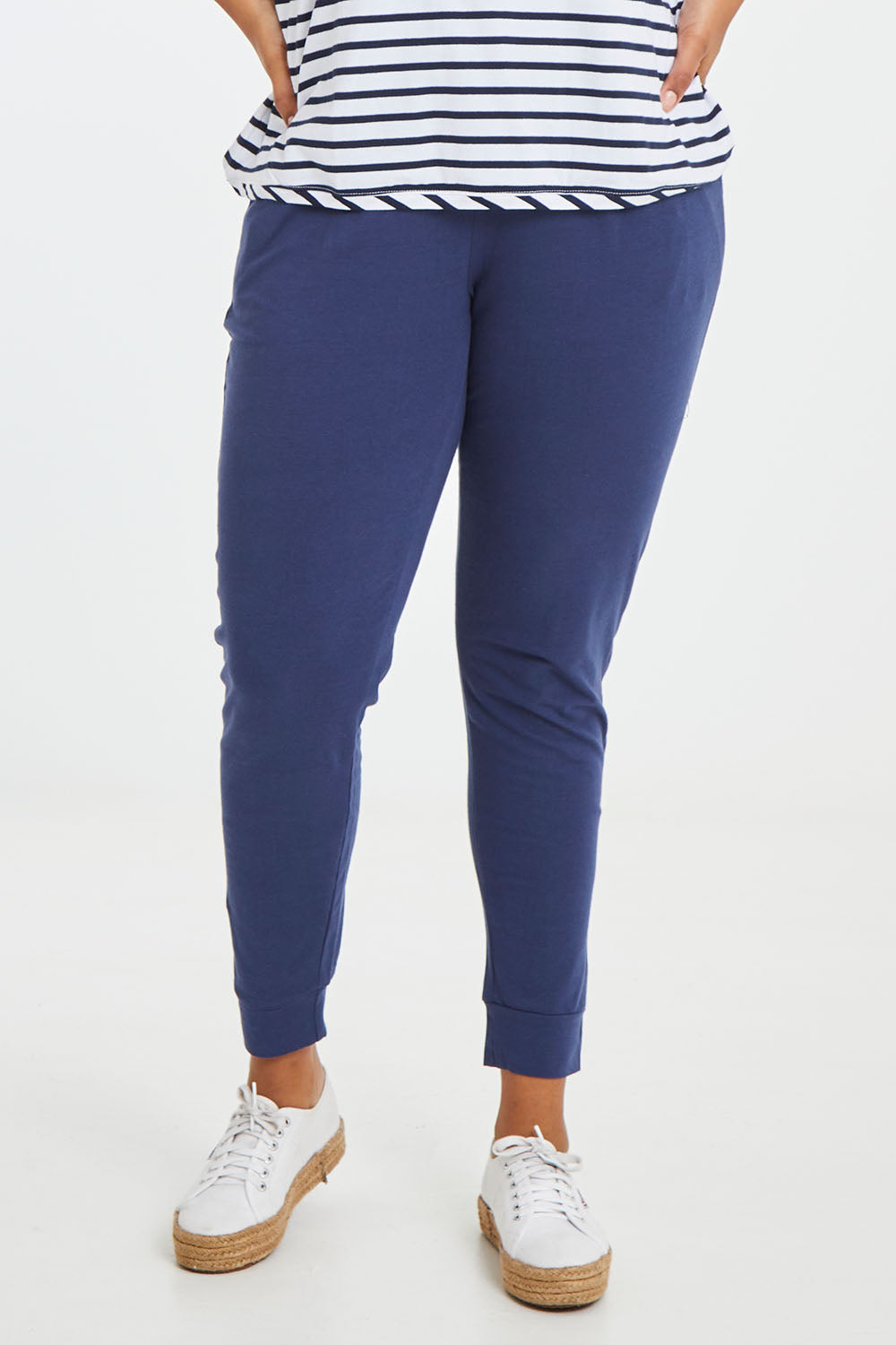 Model Noli wearing size 14 of the Heidi Pant in colour Navy (Blue), from the front, cropped image
