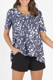 Model Madeline wearing size 10 of the Noosa Tee in colour Bengal (Blue), from the front, cropped image