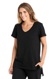 A model wearing the Billie Tee in colour Black (Black), from the front, cropped image