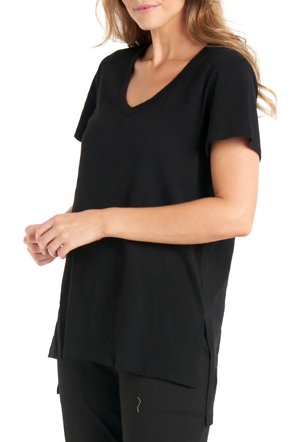 A model wearing the Billie Tee in colour Black (Black), from the front, cropped image