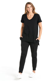 A model wearing the Billie Tee in colour Black (Black), from the front, showing the whole outfit