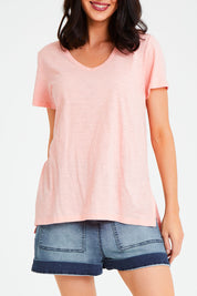 Model Andrea wearing size 10 of the Billie Tee in colour Granita (Pink), from the front, cropped image