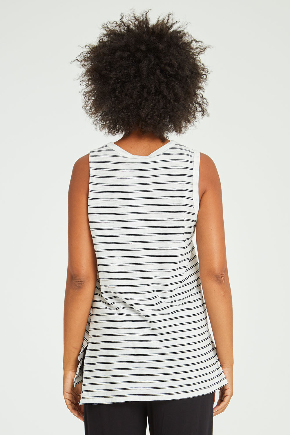 Model Olivia wearing size 10 of the Audrey Tank in colour Whiteblack (White), from the back