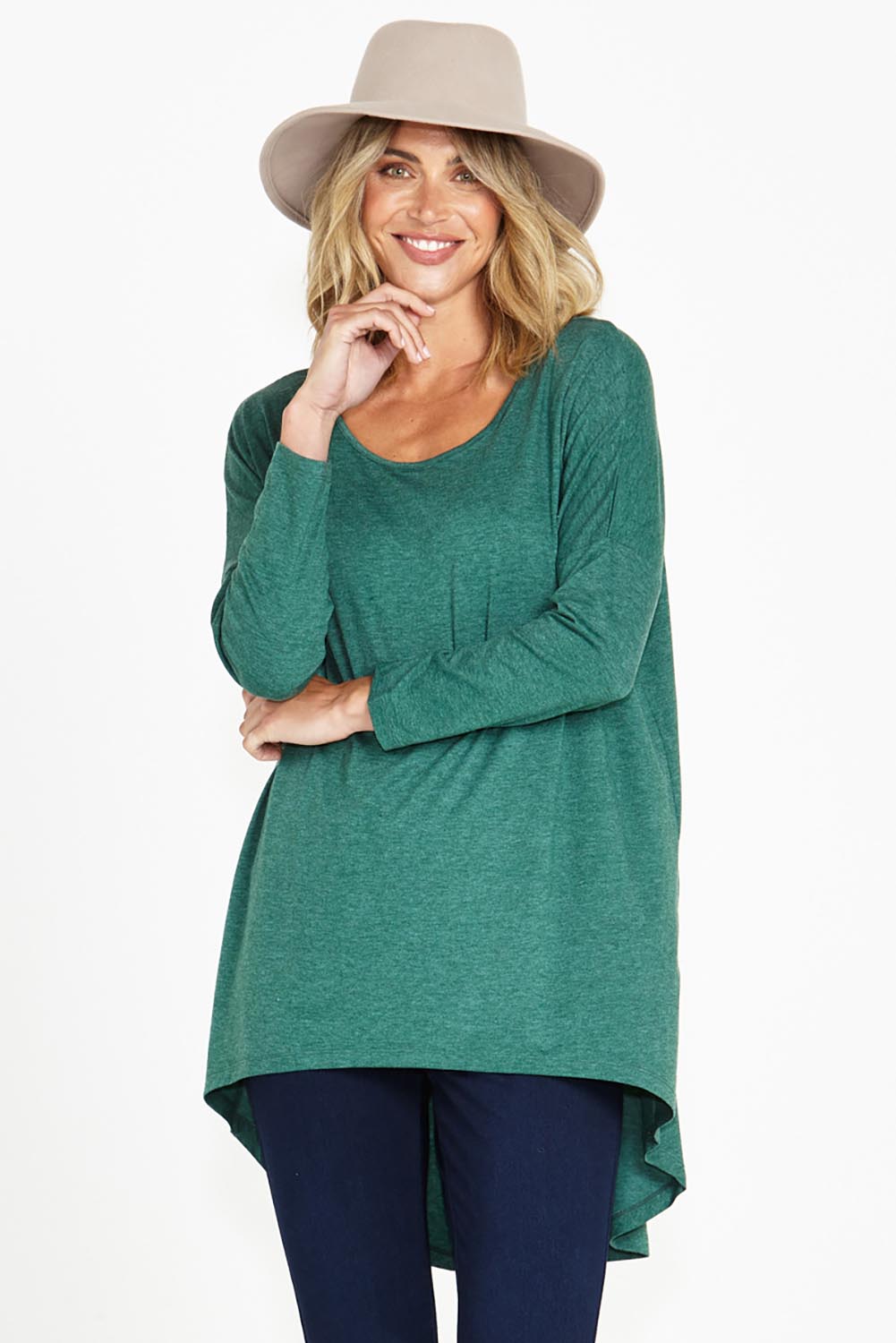 A model wearing the Celeste Tunic Tee in colour Greenmarle (Green), from the front, cropped image