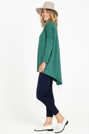 A model wearing the Celeste Tunic Tee in colour Greenmarle (Green), from the front, showing the whole outfit