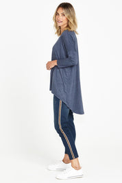 A model wearing the Celeste Tunic Tee in colour Navymarle (Blue), from the back