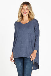 A model wearing the Celeste Tunic Tee in colour Navymarle (Blue), from the front, cropped image