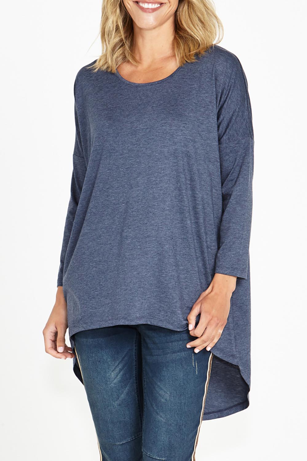 A model wearing the Celeste Tunic Tee in colour Navymarle (Blue), from the front, cropped image
