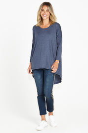 A model wearing the Celeste Tunic Tee in colour Navymarle (Blue), from the front, showing the whole outfit