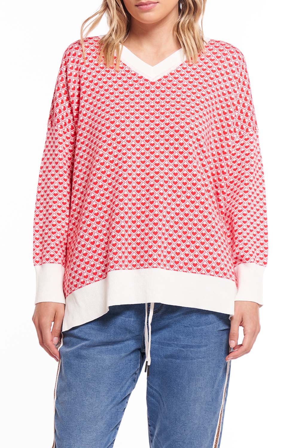 A model wearing the Gianna Sweater in colour Heart (Red), from the front, cropped image