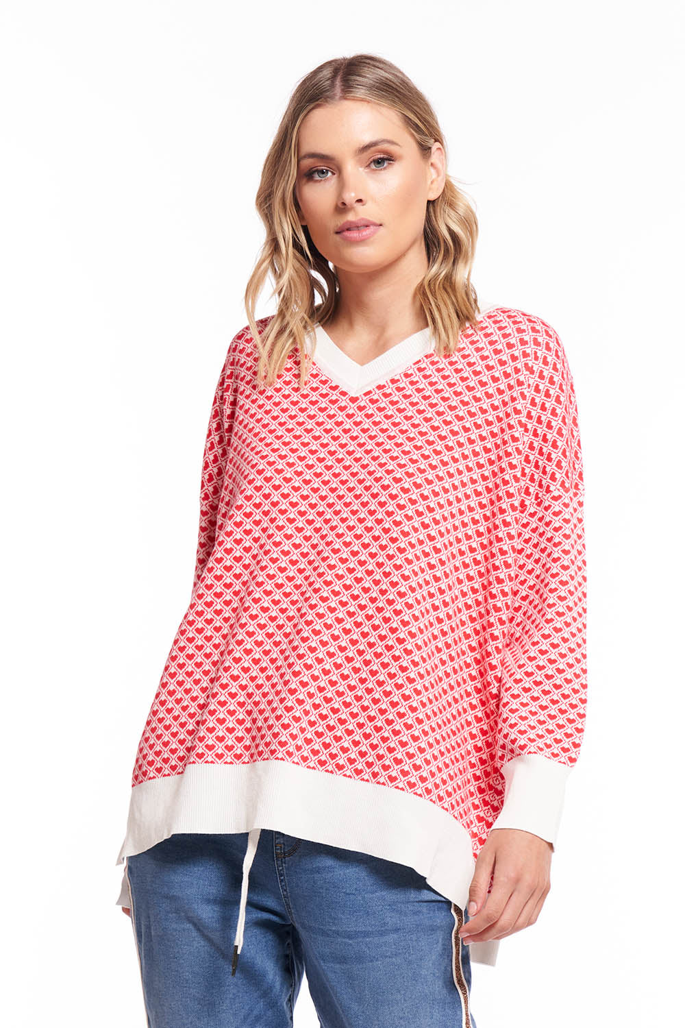 A model wearing the Gianna Sweater in colour Heart (Red), from the front, cropped image