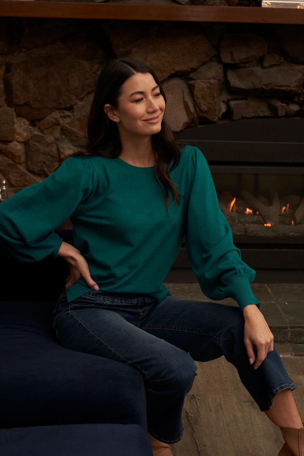 A model wearing the Charlotte Knit Jumper in colour Teal (Green), from the front, showing the whole outfit