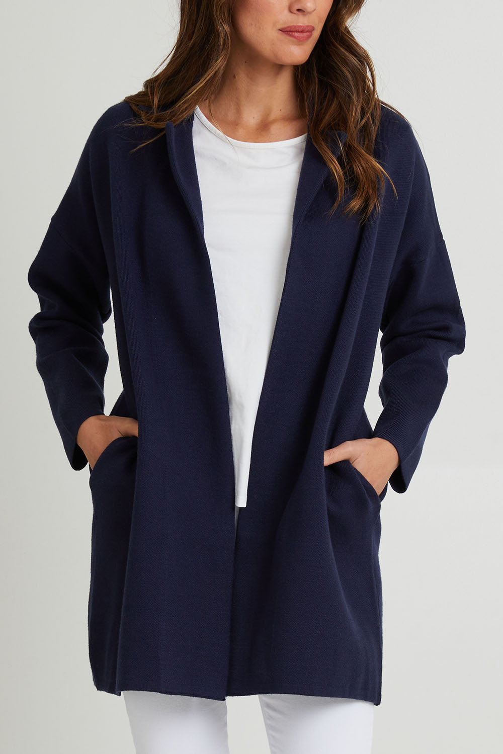 Model Madeline wearing size 10 of the Bristol Coatigan in colour Midnight (Blue), from the front, cropped image