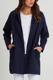 Model Madeline wearing size 10 of the Bristol Coatigan in colour Midnight (Blue), from the front, cropped image