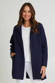 Model Madeline wearing size 10 of the Bristol Coatigan in colour Midnight (Blue), from the front, cropped image