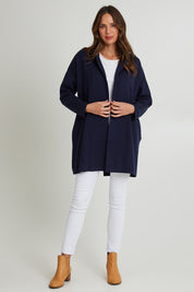 Model Madeline wearing size 10 of the Bristol Coatigan in colour Midnight (Blue), from the front, showing the whole outfit