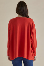 A model wearing the Destiny Knit Jumper in colour Flame (Red), from the back