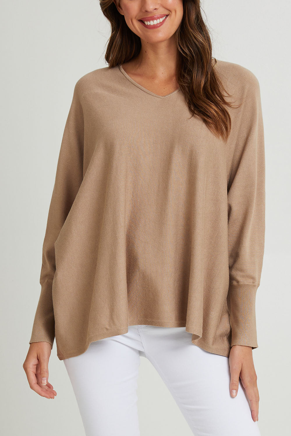 Model Madeline wearing size 10 of the Destiny Knit Jumper in colour Latte, from the front, cropped image