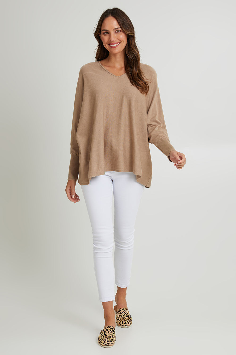 Model Madeline wearing size 10 of the Destiny Knit Jumper in colour Latte, from the front, showing the whole outfit