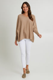 Model Madeline wearing size 10 of the Destiny Knit Jumper in colour Latte, from the front, showing the whole outfit