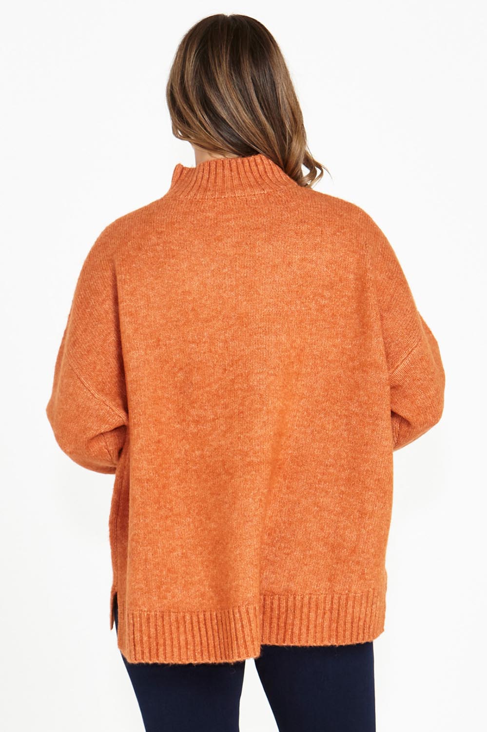 A model wearing the Luna Knit Jumper in colour Amber, from the back