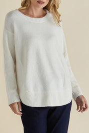 A model wearing the Soho Knit Sweater in colour Oat, from the front, cropped image