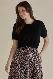 A model wearing the Robbie Knit Tee in colour Black (Black), from the front, cropped image