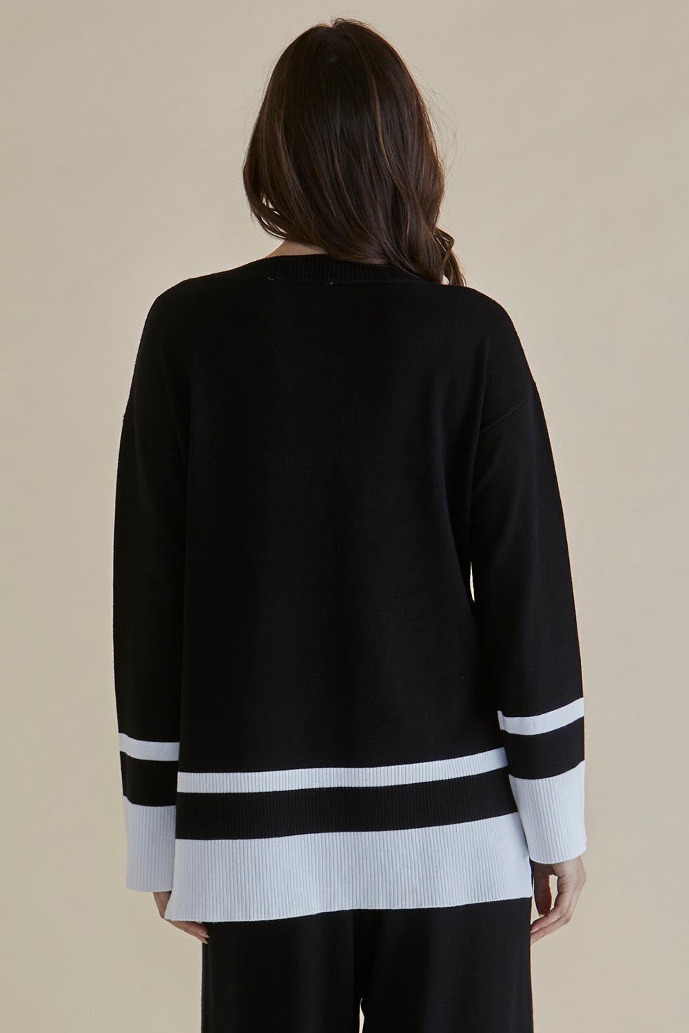 A model wearing the Eleanor Knit Jumper in colour Black (Black), from the back
