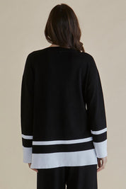 A model wearing the Eleanor Knit Jumper in colour Black (Black), from the back