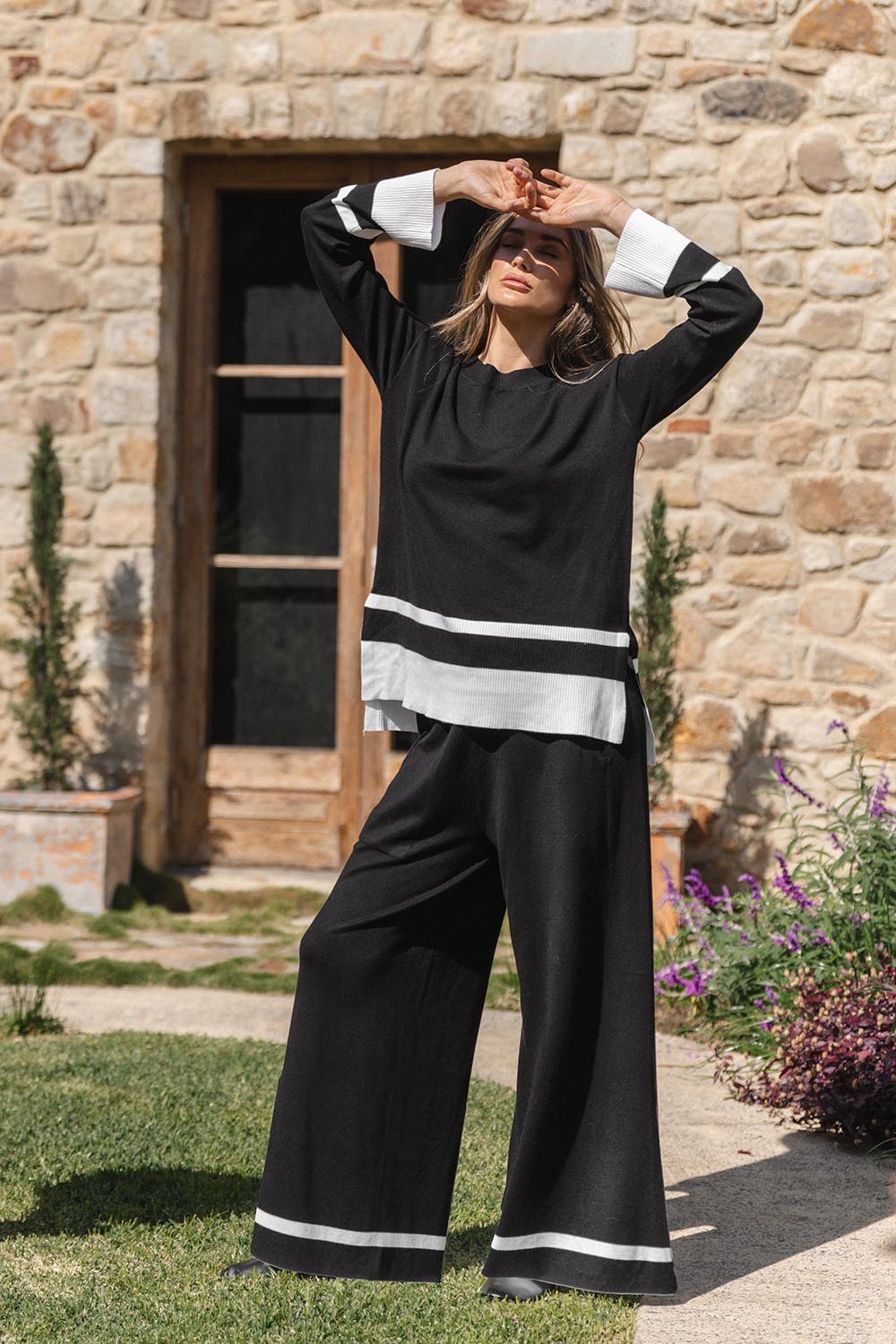 A model wearing the Eleanor Knit Jumper in colour Black (Black), from the front, showing the whole outfit