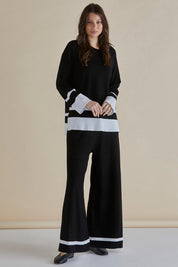 A model wearing the Eleanor Knit Jumper in colour Black (Black), from the front, showing the whole outfit